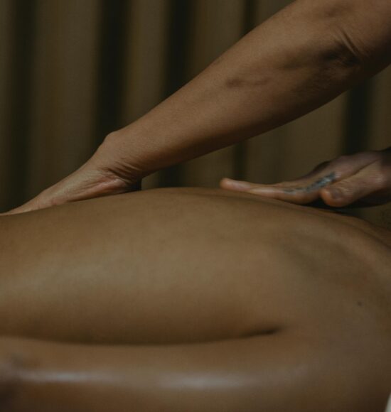 A calming spa massage with hands gently massaging a client's back for ultimate relaxation.